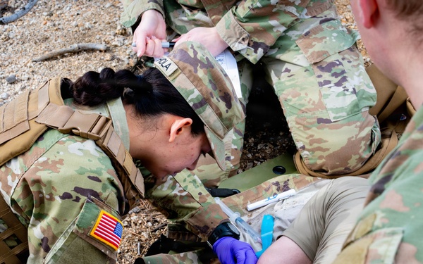 Medics perform medical assessment on casualty