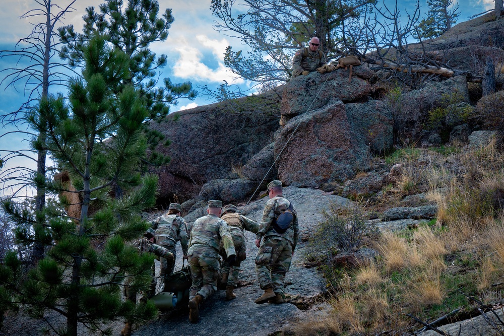 Medics maneuver casualty across terrain