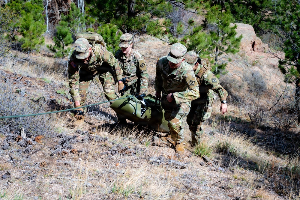 Medics maneuver casualty across terrain