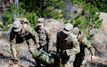 Medics maneuver casualty across terrain