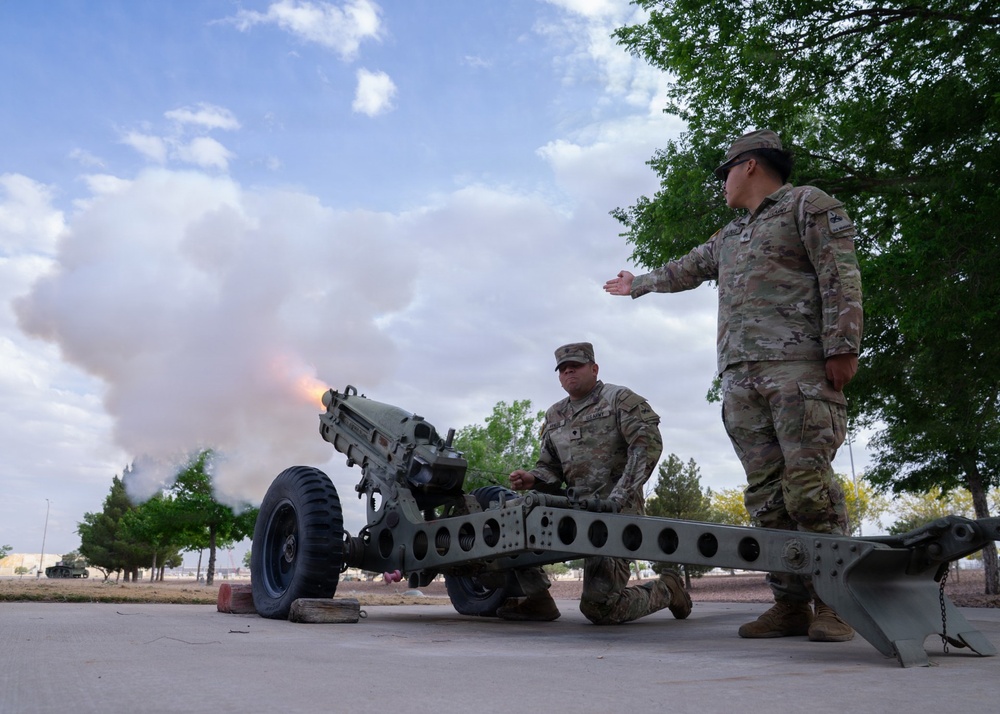 1st Armored Division Soldiers Fire cannon during the lowering of U.S. flag at Fort Bliss