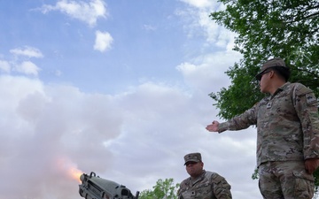 1st Armored Division Soldiers Fire cannon during the lowering of U.S. flag at Fort Bliss