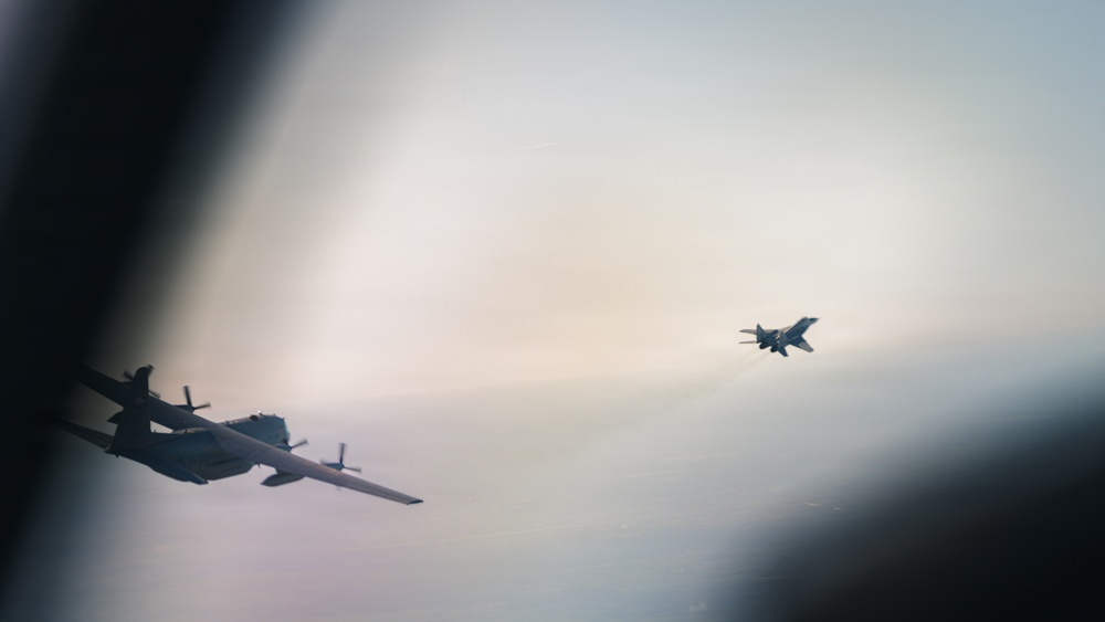 180th Airlift Squadron airmen fly alongside a MiG-29 fighter jet