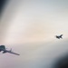 180th Airlift Squadron airmen fly alongside a MiG-29 fighter jet