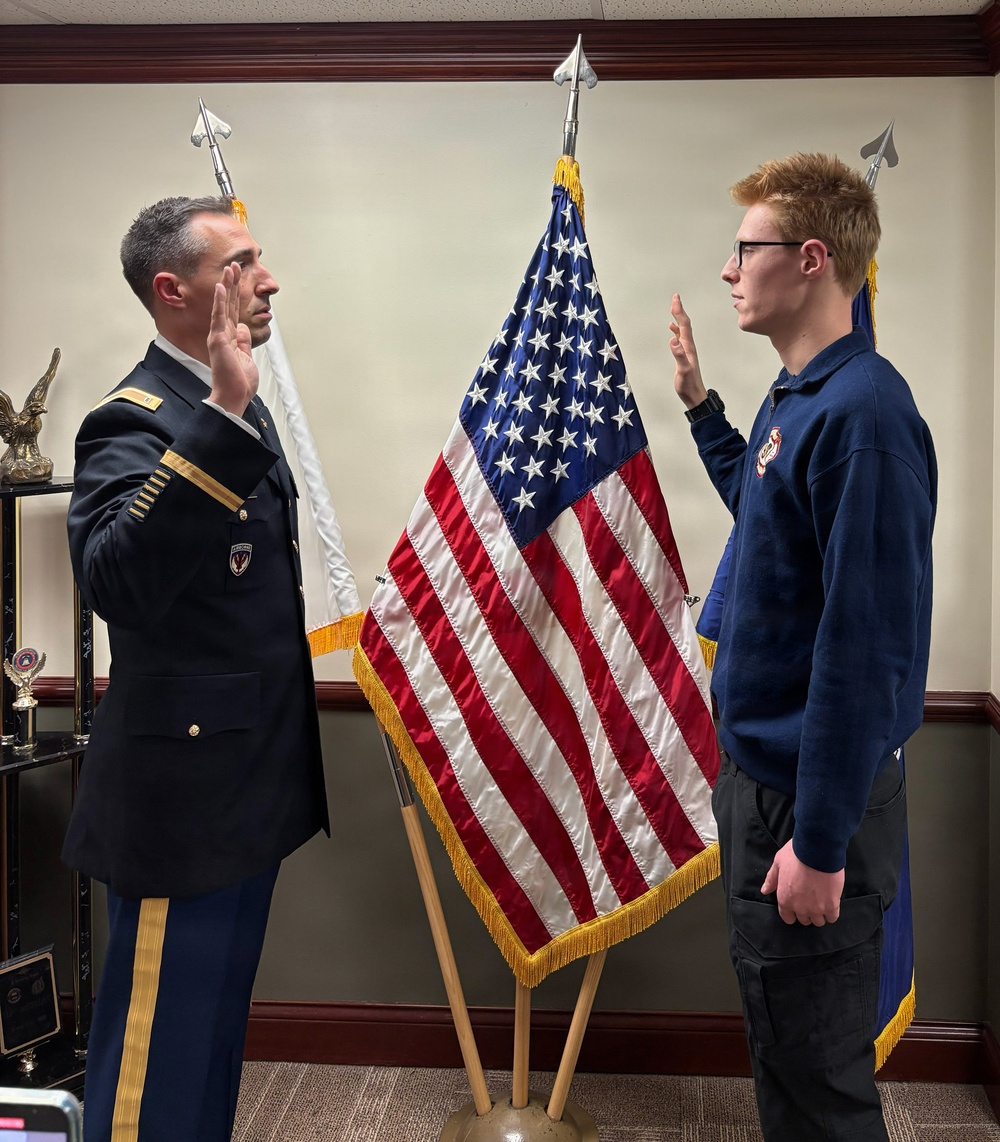 CW3 David Durbin enlisting Spc. Christian Durbin