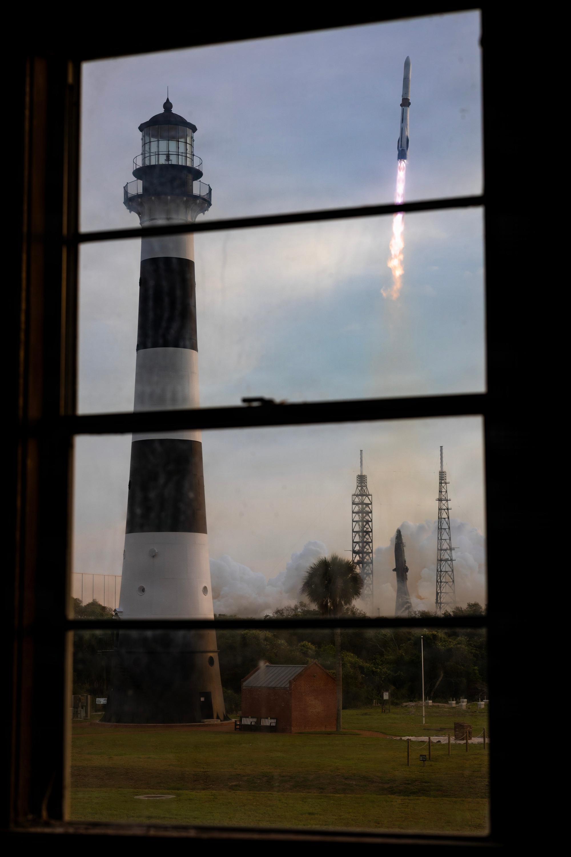 New Glenn rising after liftoff with a bright plume over the Florida coast