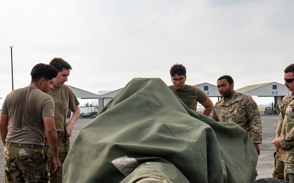 Balikatan 2026: 317th AW, 25th ID load Humvee, howitzer onto C-130J