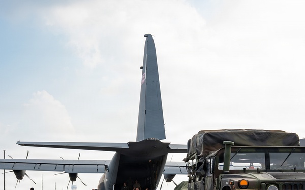 Balikatan 2026: 317th AW, 25th ID load Humvee, howitzer onto C-130J