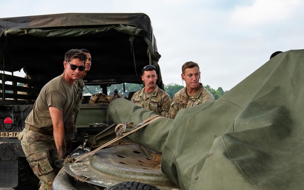 Balikatan 2026: 317th AW, 25th ID load Humvee, howitzer onto C-130J