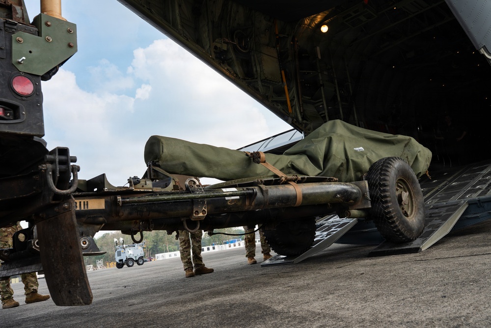 Balikatan 2026: 317th AW, 25th ID load Humvee, howitzer onto C-130J