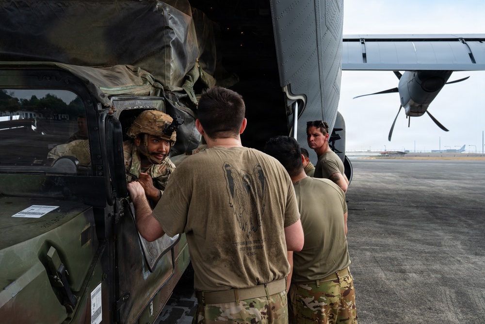 Balikatan 2026: 317th AW, 25th ID load Humvee, howitzer onto C-130J
