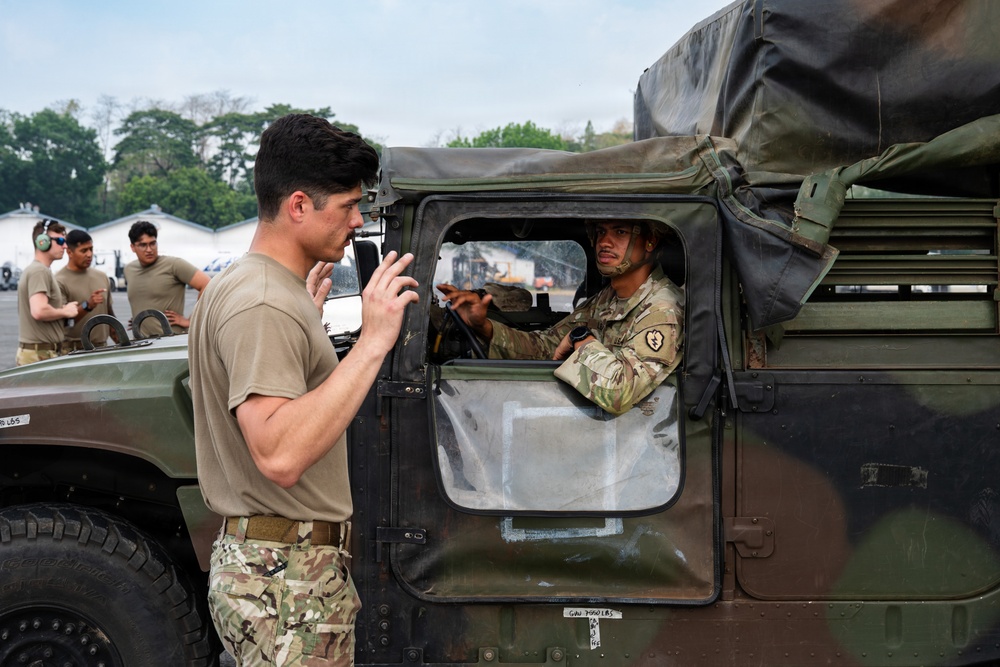 Balikatan 2026: 317th AW, 25th ID load Humvee, howitzer onto C-130J