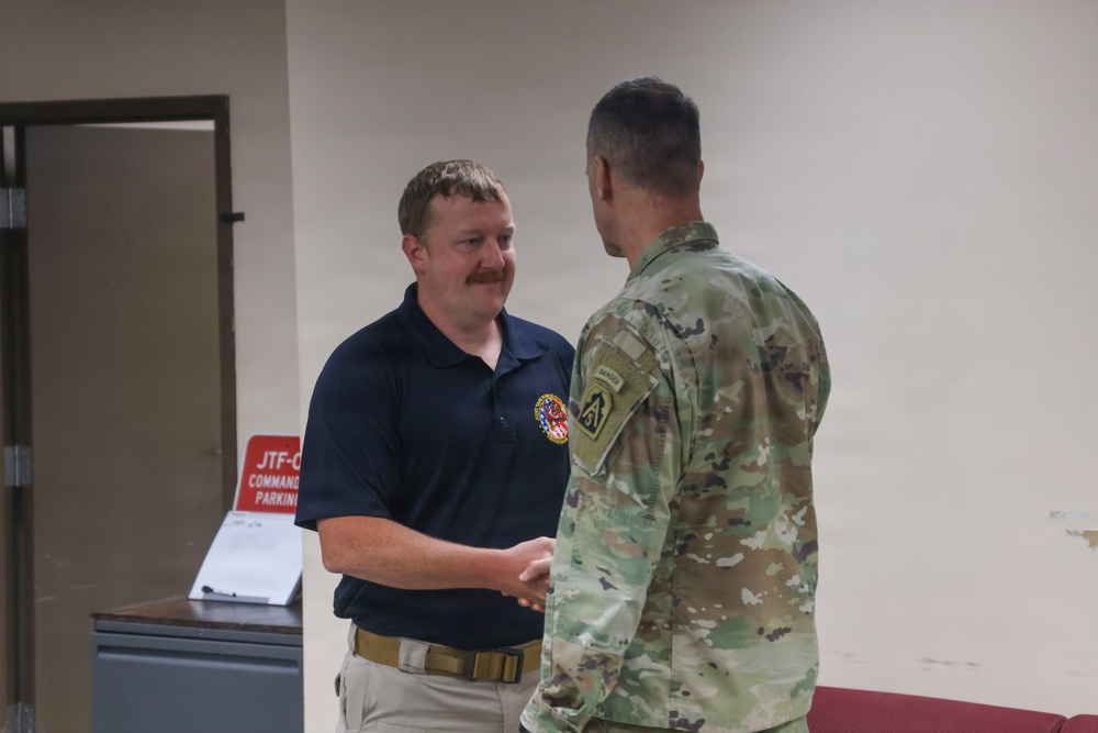 General Pepin Presents Coins to JTF-CS