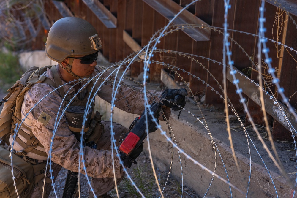 U.S. Marines with JTF-SB repair breach sites along southern barrier