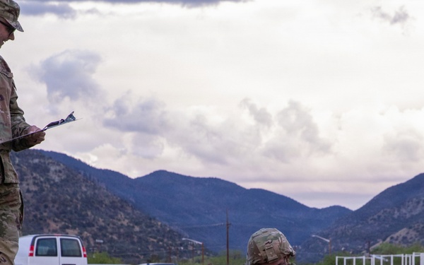 U.S. Army soldier performs low crawl during physical fitness assessment at mountainous training installation