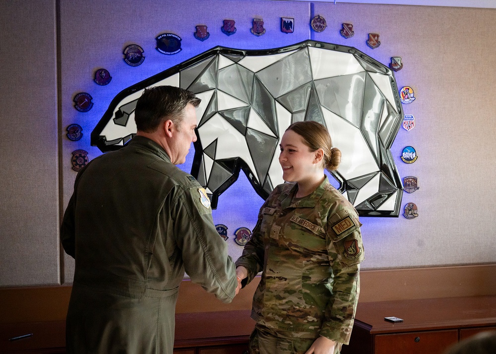 168th Wing Commander presents his Commander Coin to 354th Medical Group Airmen