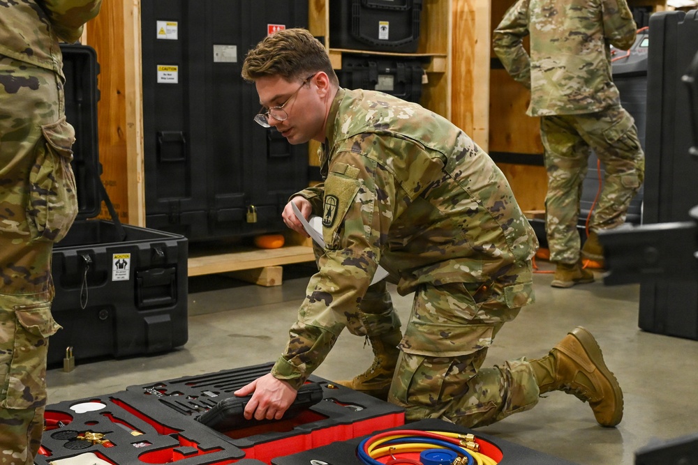 U.S. Army Tank-automotive and Armaments Command and Capability Program Executive for Combat Logistics team members field Refrigeration Tool Kits to members of Wisconsin Army National Guard
