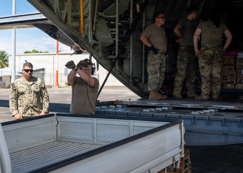 U.S. Air Force and Navy service members download medical supplies during Pac Angel 26-3
