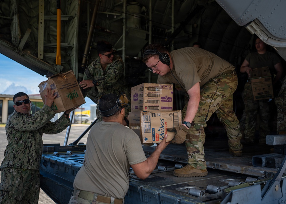U.S. Air Force and Navy service members download medical supplies during Pac Angel 26-3