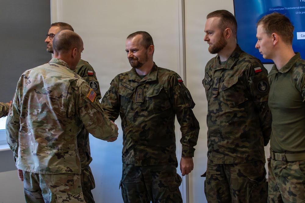 U.S. and Polish Army Personnel Receive Challenge Coins During a Physical Security Officer Course