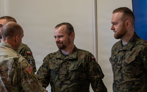 U.S. and Polish Army Personnel Receive Challenge Coins During a Physical Security Officer Course