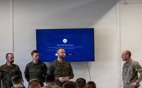 U.S. and Polish Army Personnel Receive Challenge Coins During a Physical Security Officer Course