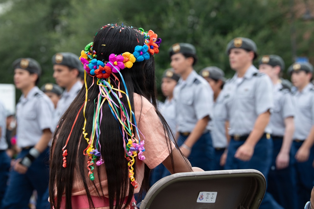 San Antonio local watches marching at 135th Battle of Flowers Parade