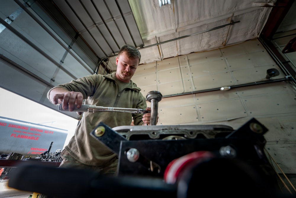 Wyoming Air National Guard member operates torque wrench during diesel repair