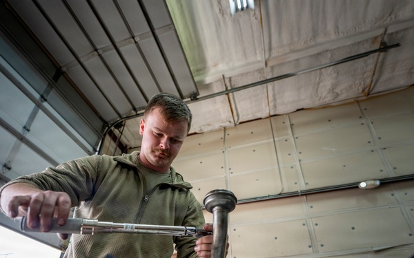Wyoming Air National Guard member operates torque wrench during diesel repair