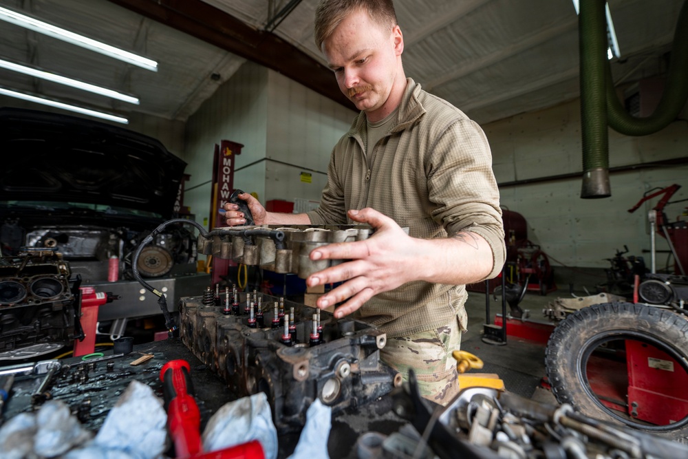 Airman prepares diesel engine for reassembly