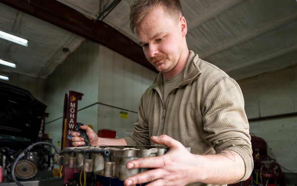 Airman prepares diesel engine for reassembly