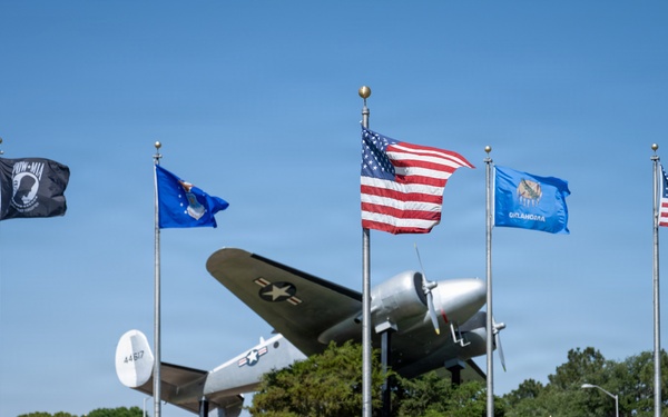 Flags on display next to C-45 Beech passenger aircraft