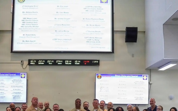 U.S. Navy personnel and civilian staff pose for group photo during Bravo Zulu and Special Recognition ceremony