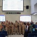 U.S. Navy personnel and civilian staff pose for group photo during Bravo Zulu and Special Recognition ceremony