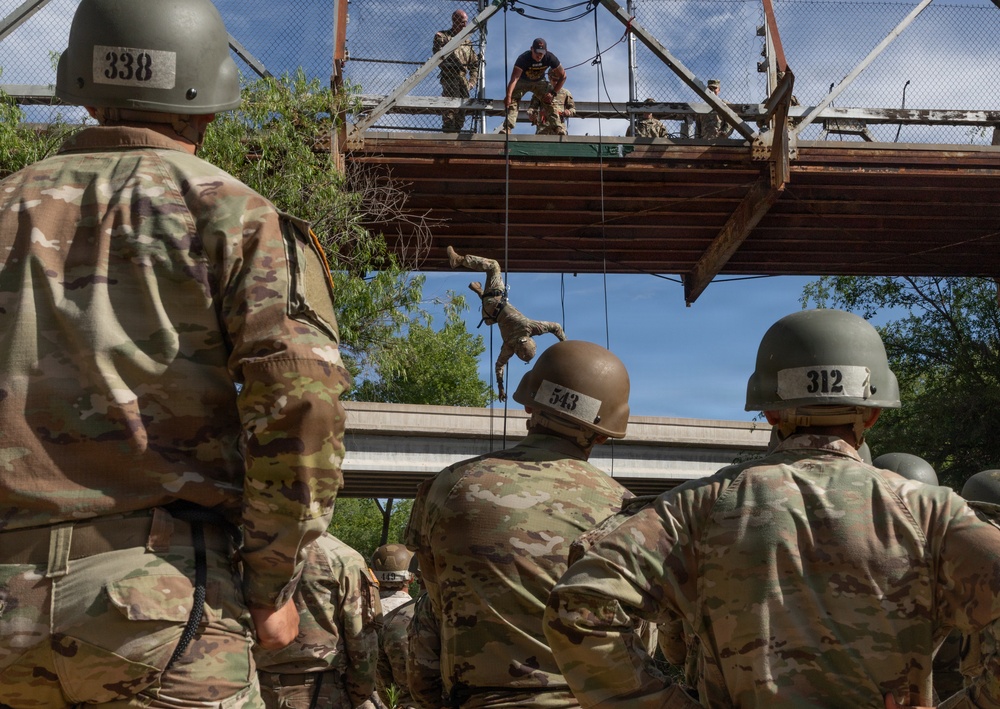 JTF-SB service members rappel from bridge during Air Assault training