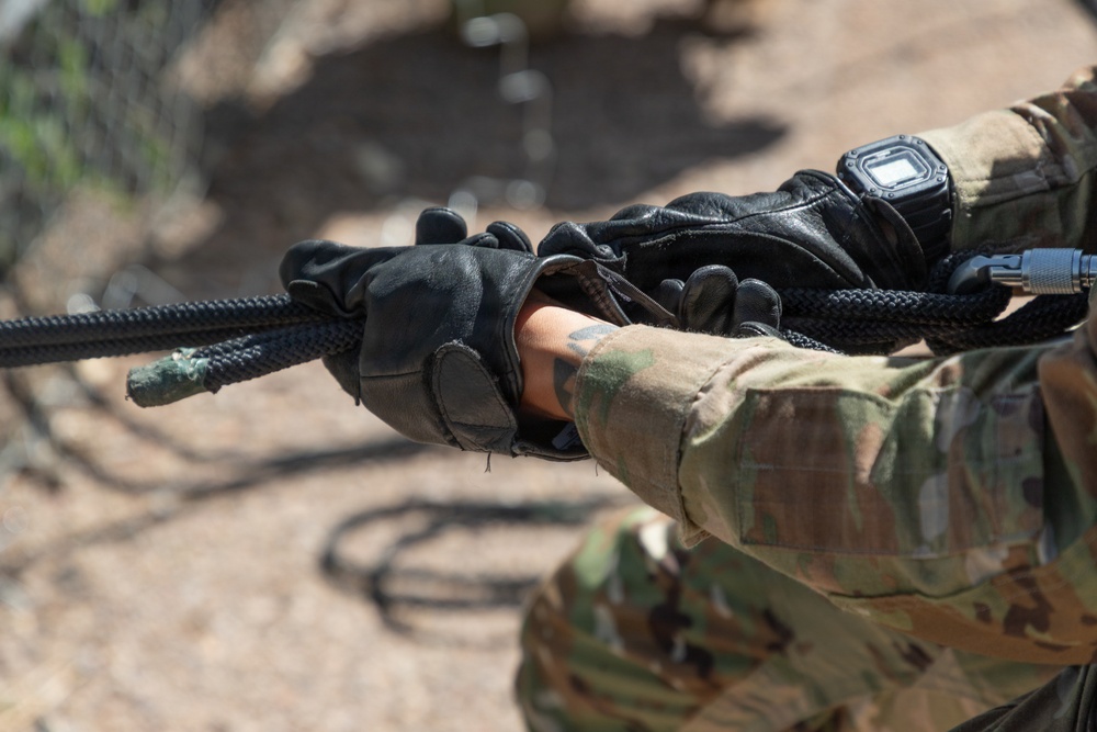JTF-SB service members rappel from bridge during Air Assault training