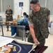 Sergeant Major of the Marine Corps Carlos Ruiz examines a nearly completed Presidential flag during a visit to Defense Logistics Agency Troop Support in Philadelphia on April 27.