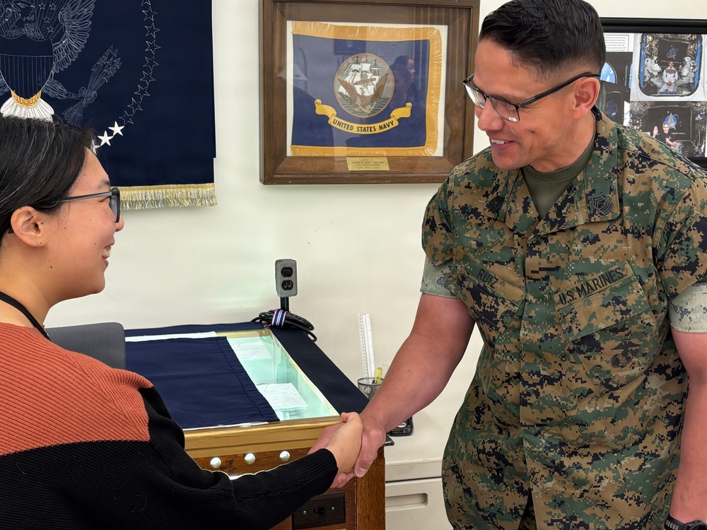 Sergeant Major of the Marine Corps Carlos Ruiz examines a nearly completed Presidential flag during a visit to Defense Logistics Agency Troop Support in Philadelphia on April 27.
