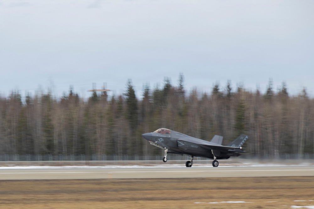 U.S. service members unload ordnance from aircraft participating in exercise Red Flag-Alaska