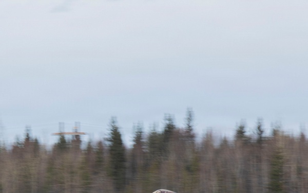 U.S. service members unload ordnance from aircraft participating in exercise Red Flag-Alaska