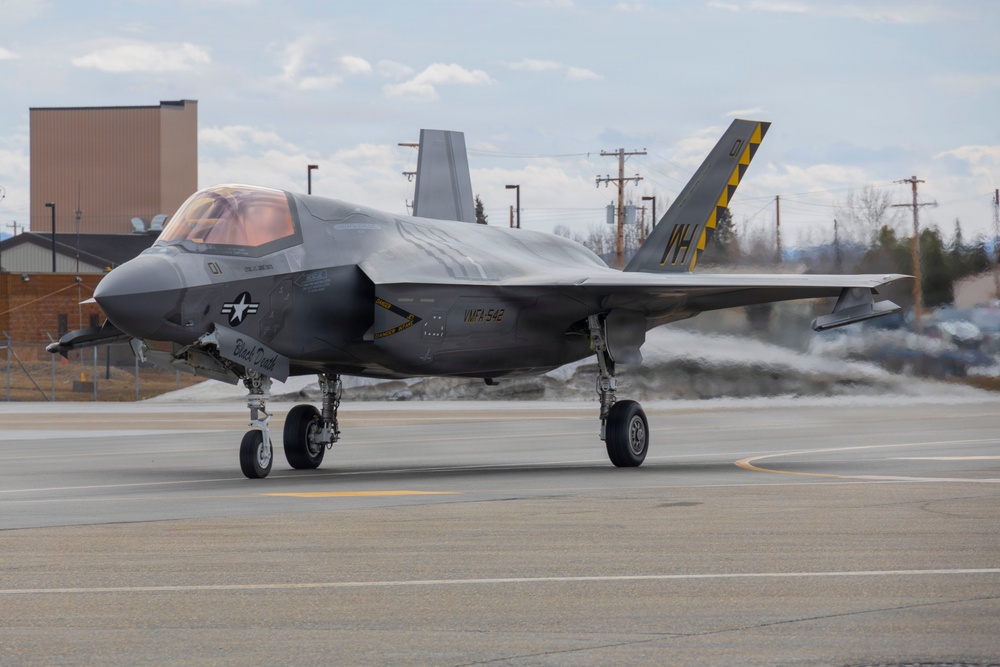 U.S. service members unload ordnance from aircraft participating in exercise Red Flag-Alaska