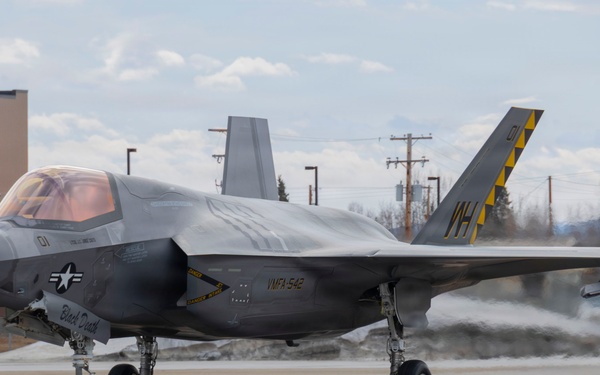 U.S. service members unload ordnance from aircraft participating in exercise Red Flag-Alaska