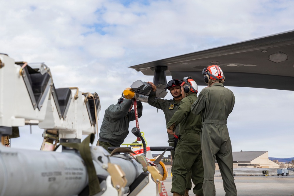 U.S. service members unload ordnance from aircraft participating in exercise Red Flag-Alaska
