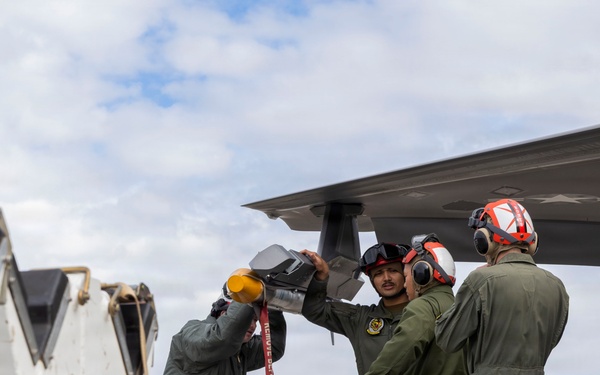 U.S. service members unload ordnance from aircraft participating in exercise Red Flag-Alaska