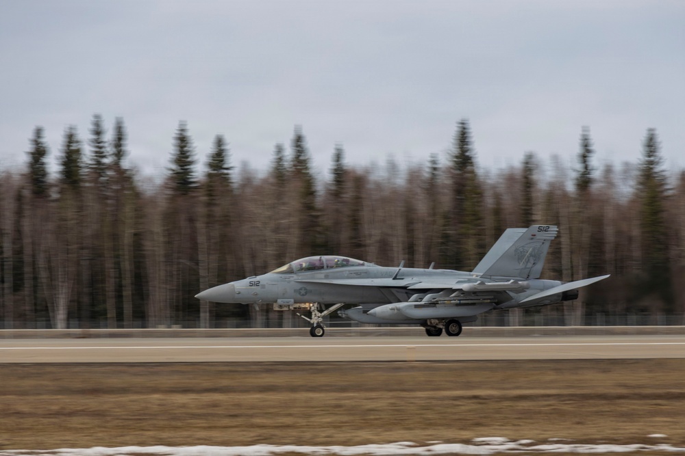 U.S. service members unload ordnance from aircraft participating in exercise Red Flag-Alaska