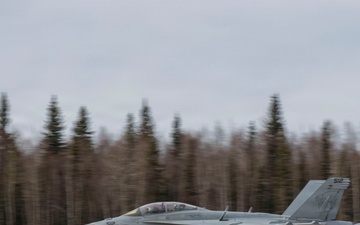 U.S. service members unload ordnance from aircraft participating in exercise Red Flag-Alaska