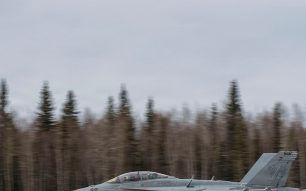U.S. service members unload ordnance from aircraft participating in exercise Red Flag-Alaska