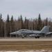 U.S. service members unload ordnance from aircraft participating in exercise Red Flag-Alaska