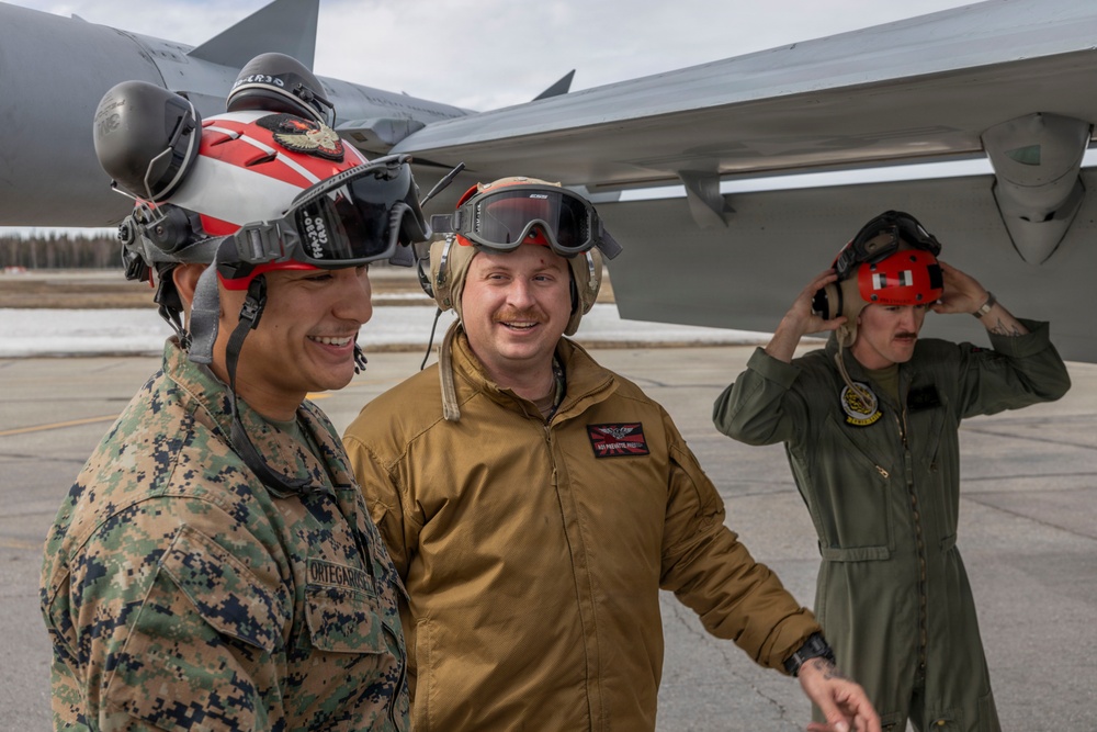 U.S. service members unload ordnance from aircraft participating in exercise Red Flag-Alaska