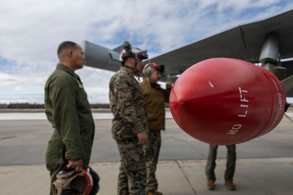 U.S. service members unload ordnance from aircraft participating in exercise Red Flag-Alaska